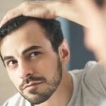 a man checking hair loss in men at side
