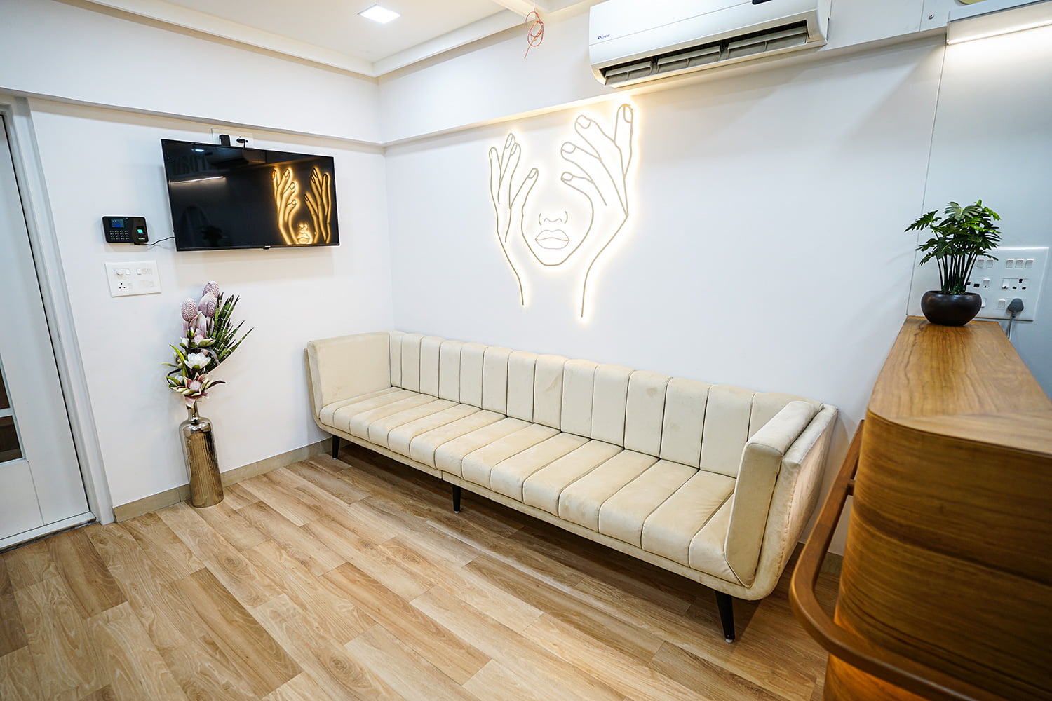 patient waiting area with beautiful backlight wall art at vadodara branch of hairgrow