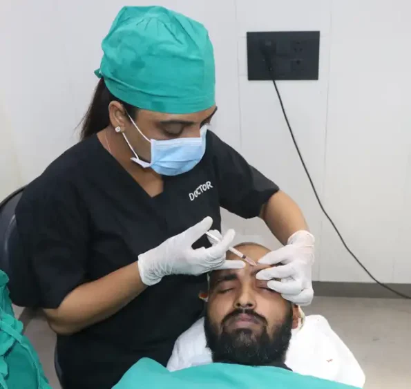 Surgeon administering local anesthesia using vibration technique