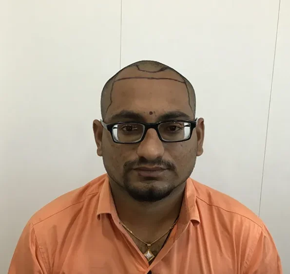 Man wearing an orange shirt.