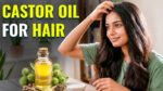Pure castor oil bottle with castor seeds and healthy hair strands illustrating the benefits of castor oil for hair growth and scalp care.