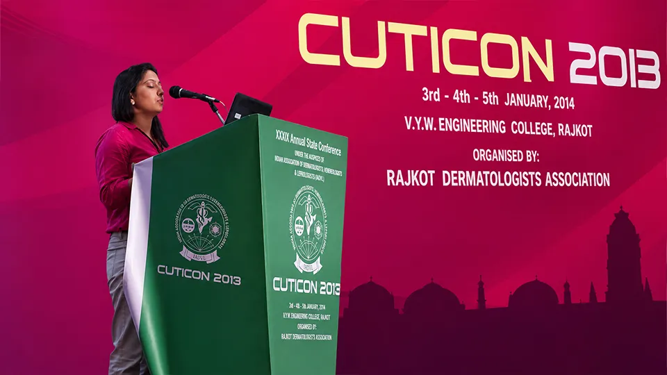 Dr. Richa Sanmukhani speaking at a dermatology conference, showcasing expertise in hair transplant and hair restoration