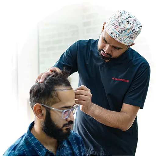 Doctor examining a patient’s hairline at HairFree & HairGrow