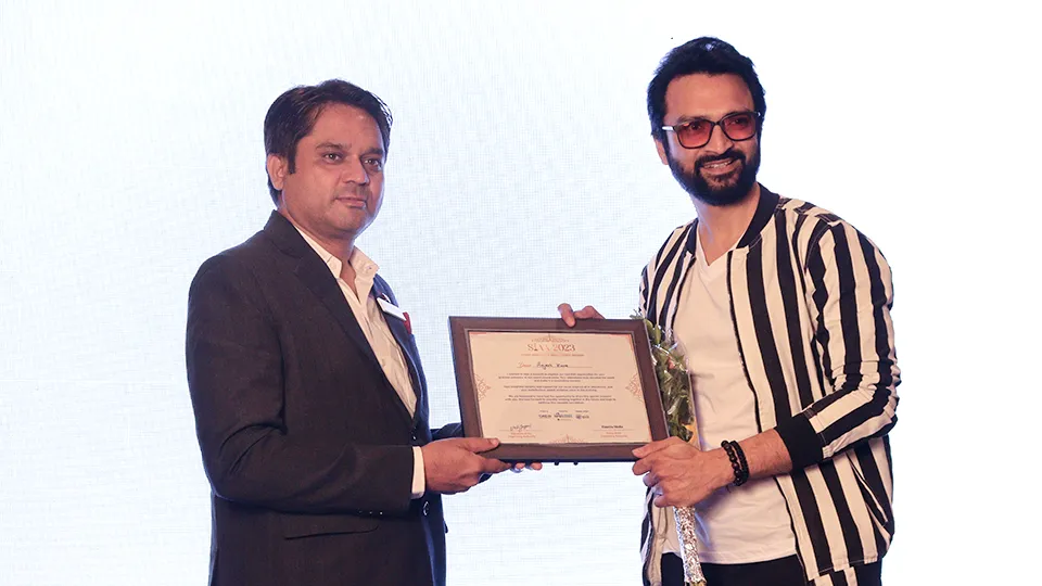 Dr. Chintan Bhavsar receiving an award at HairFree HairGrow