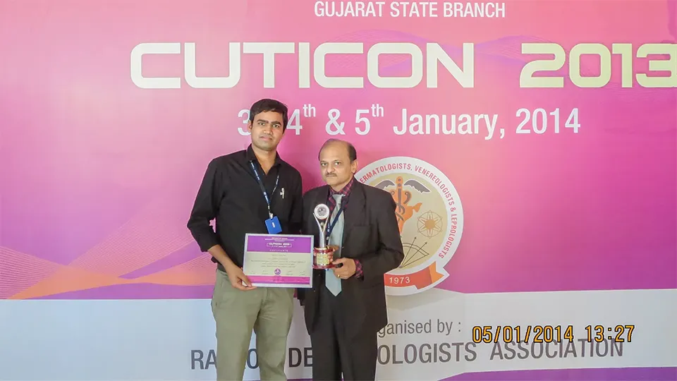 Dr. Kiran Chotaliya receiving an award at an event